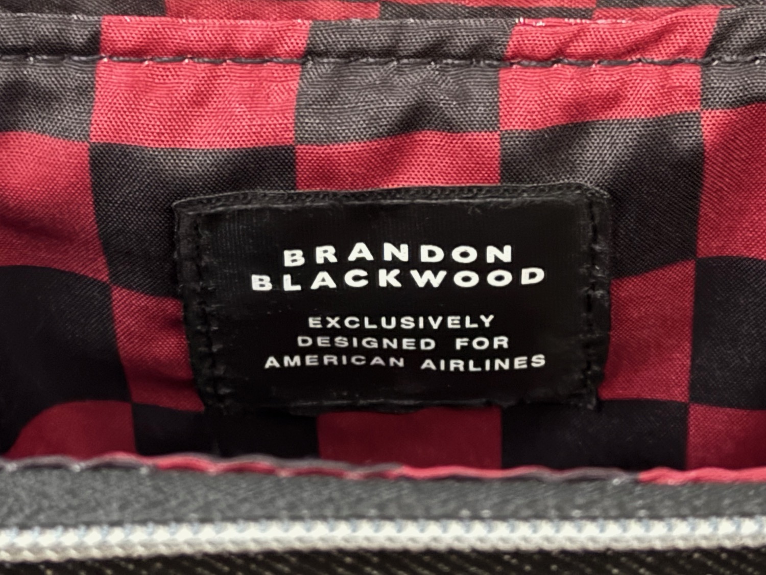 a label on a red and black plaid fabric