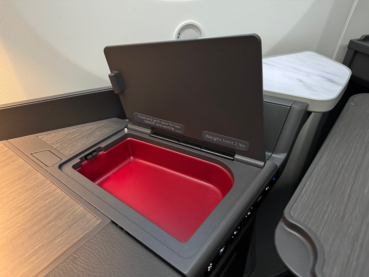 an open red tray on a plane