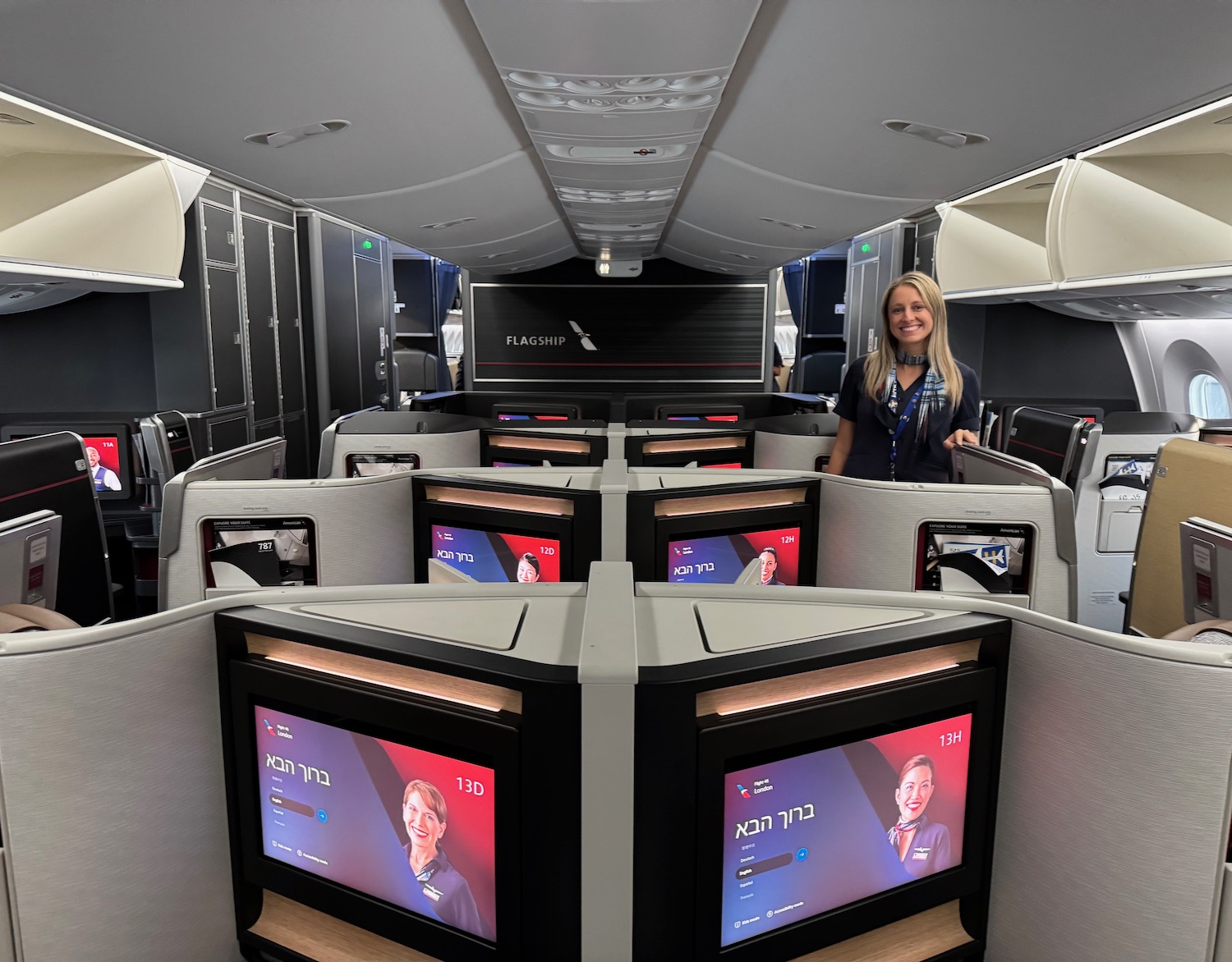 a woman standing in a room with several monitors