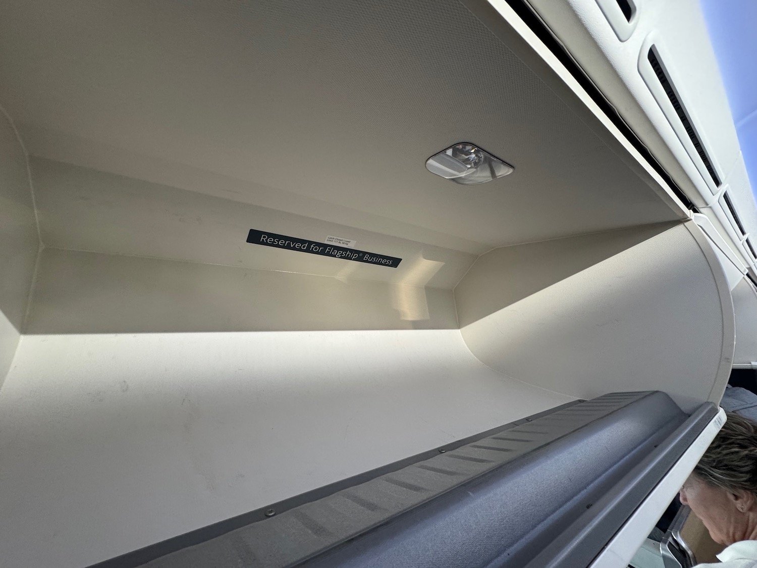 a white shelf with a light on the ceiling