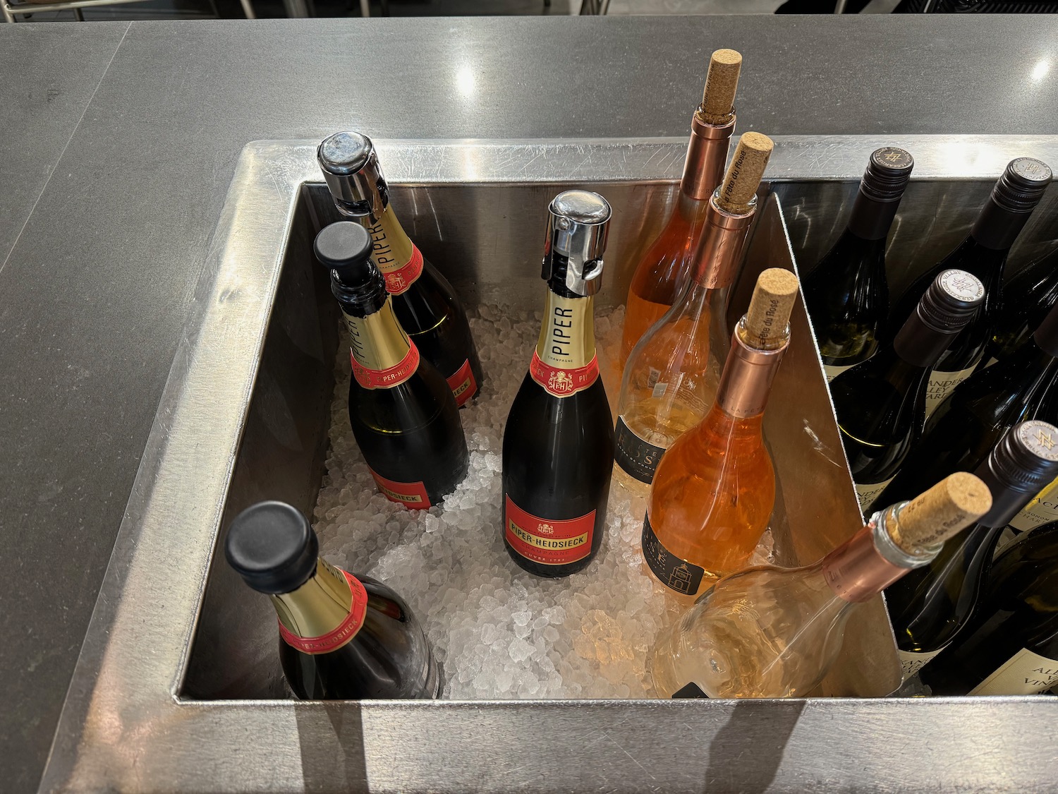 a group of bottles in a metal sink