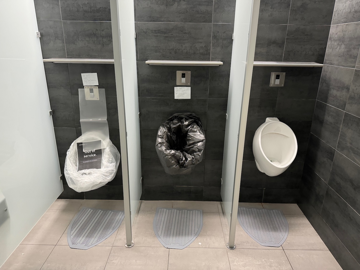 a row of urinals in a public bathroom