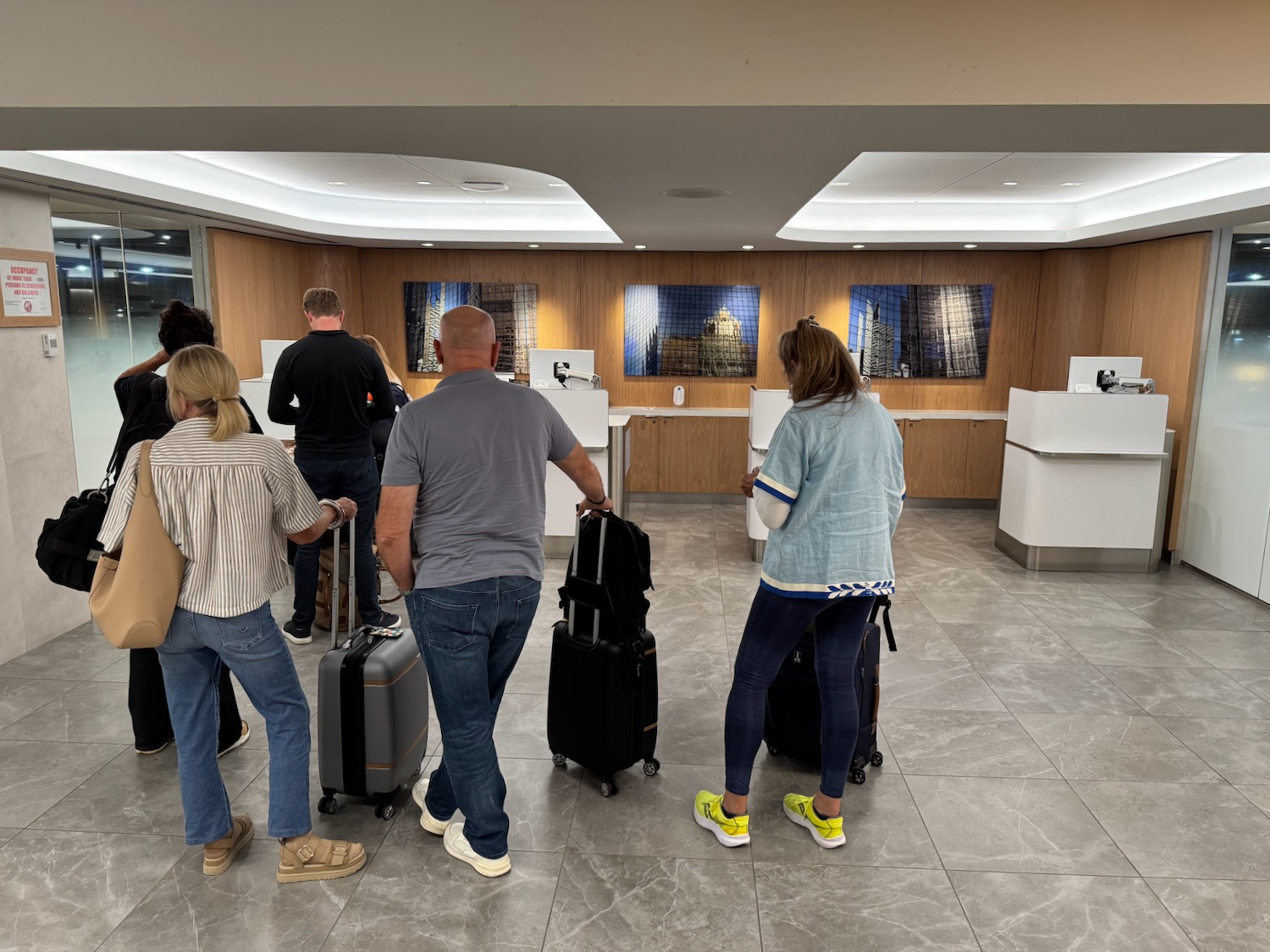 a group of people with luggage in a lobby