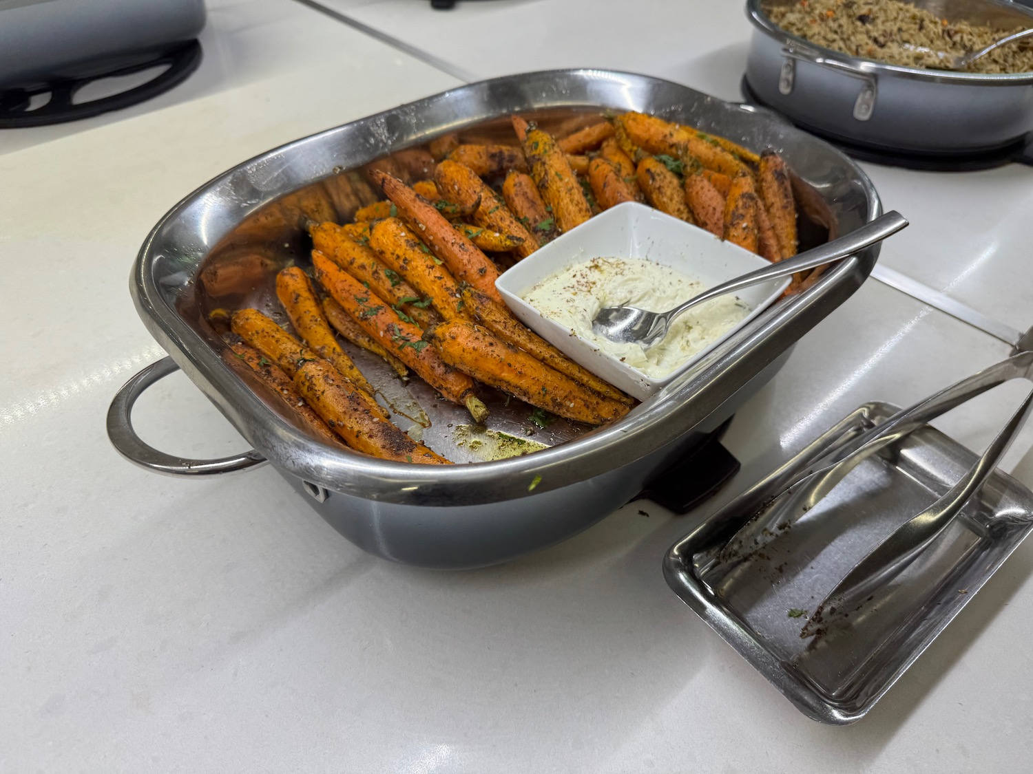 a pan of food with a white sauce in it