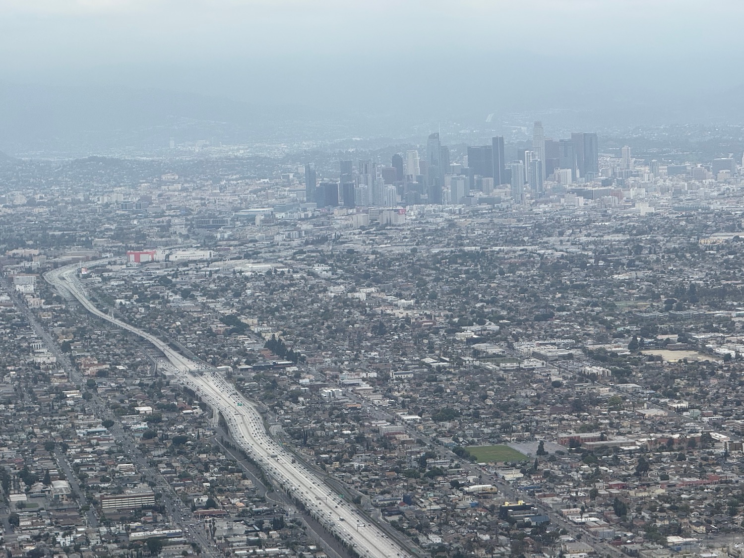 a city with a road and a city in the background