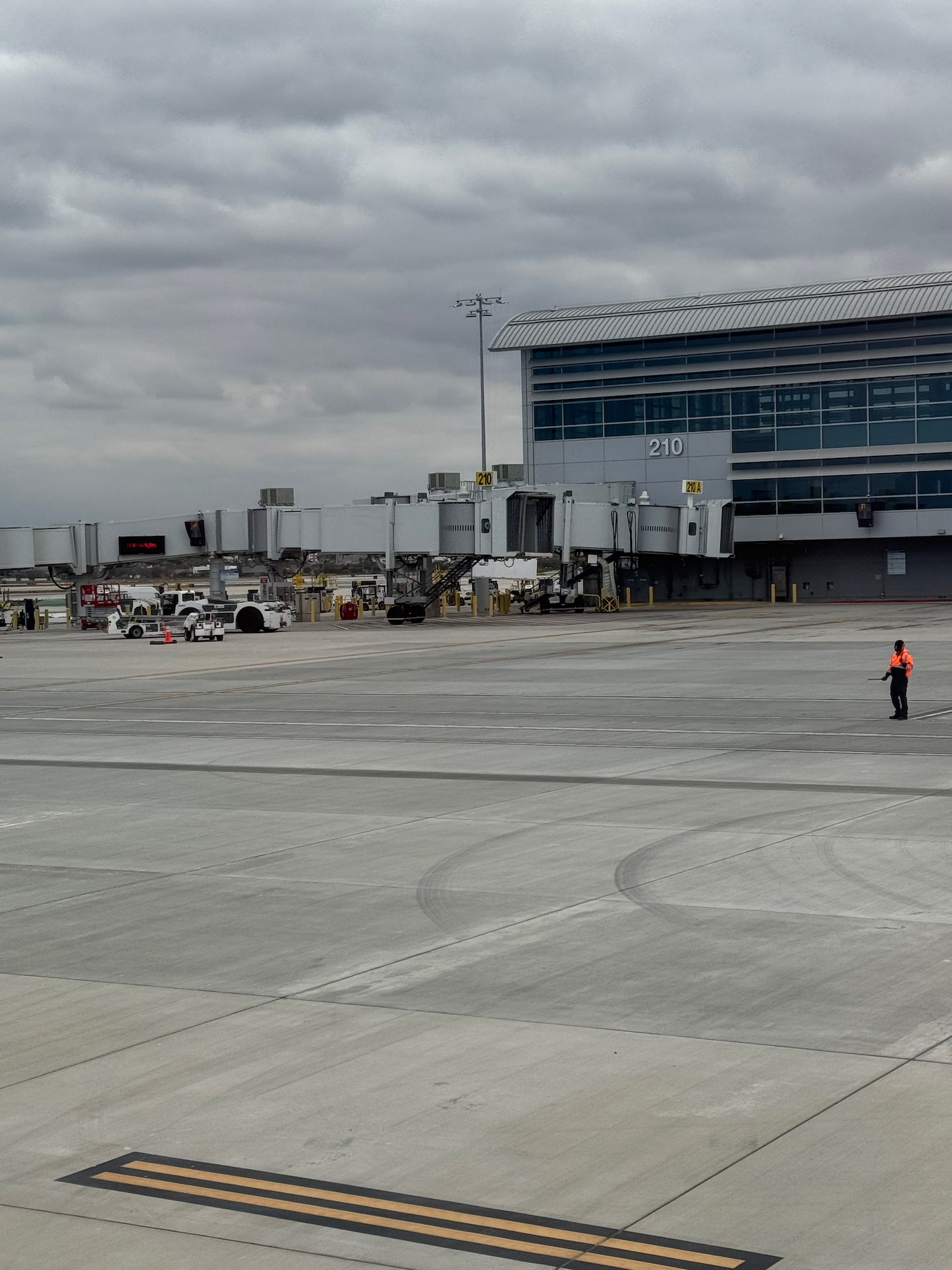 a man standing on a tarmac near a building