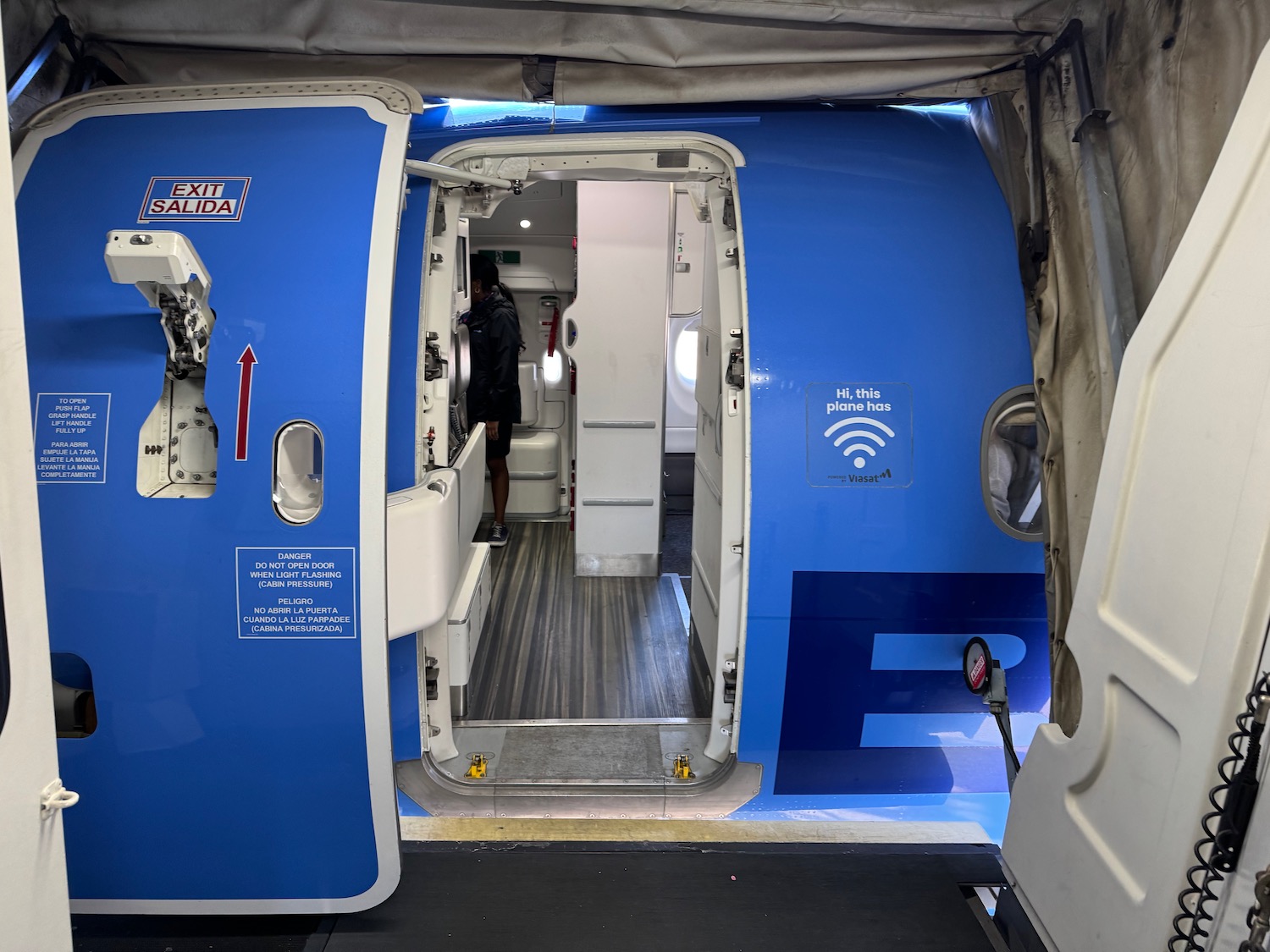 a blue and white airplane with open doors