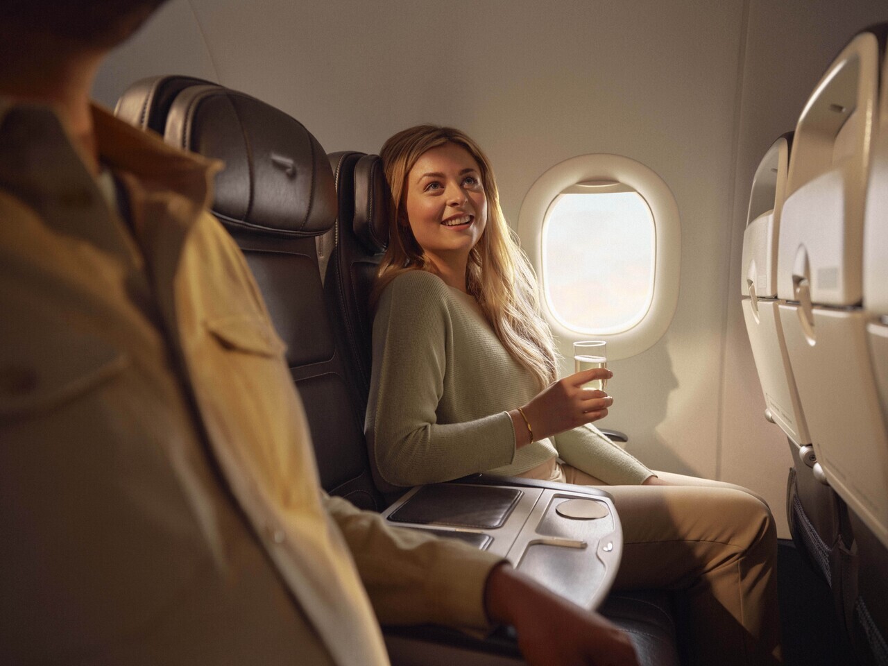 a woman sitting in a chair with a drink in her hand