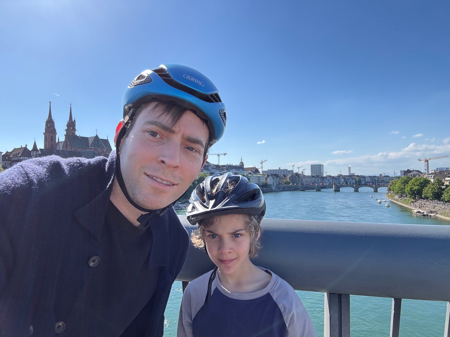 a man and child wearing helmets posing for a picture