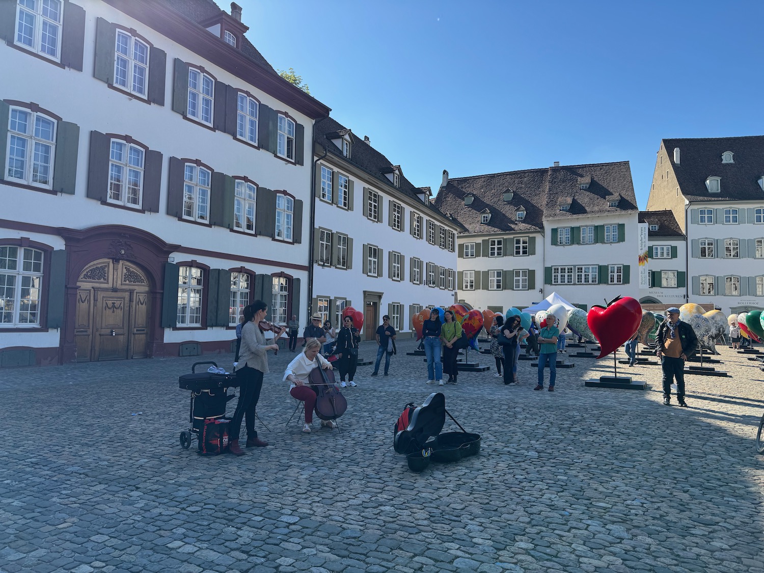 a group of people playing instruments in a courtyard