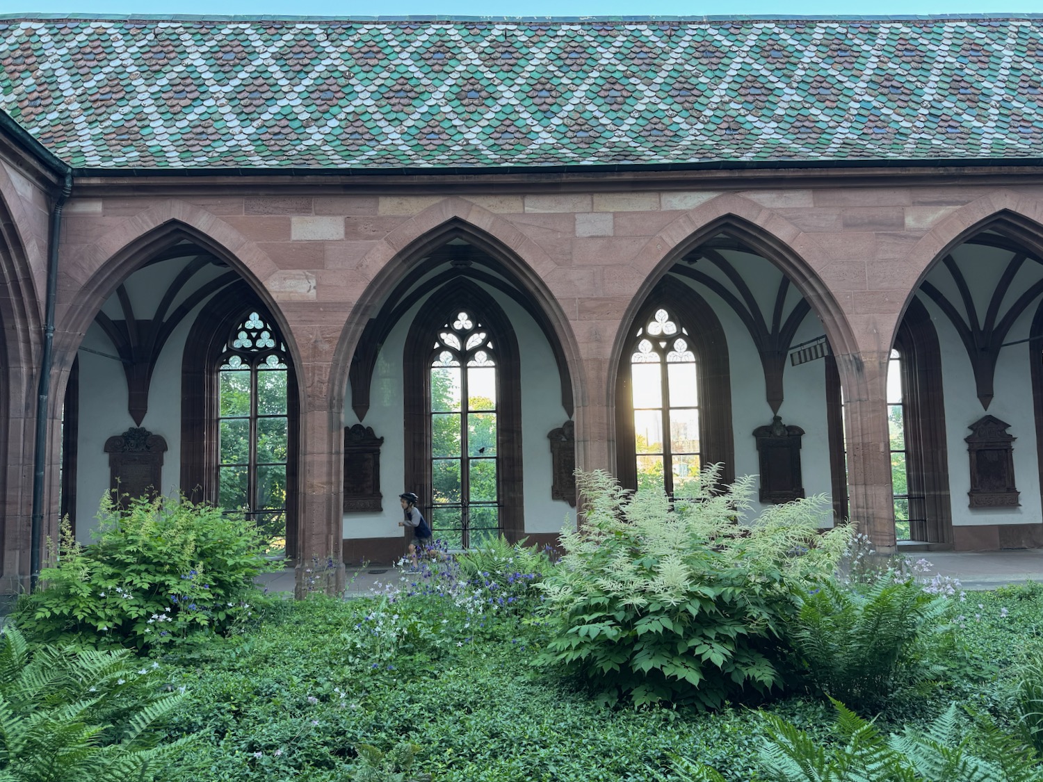a building with arched windows and a garden