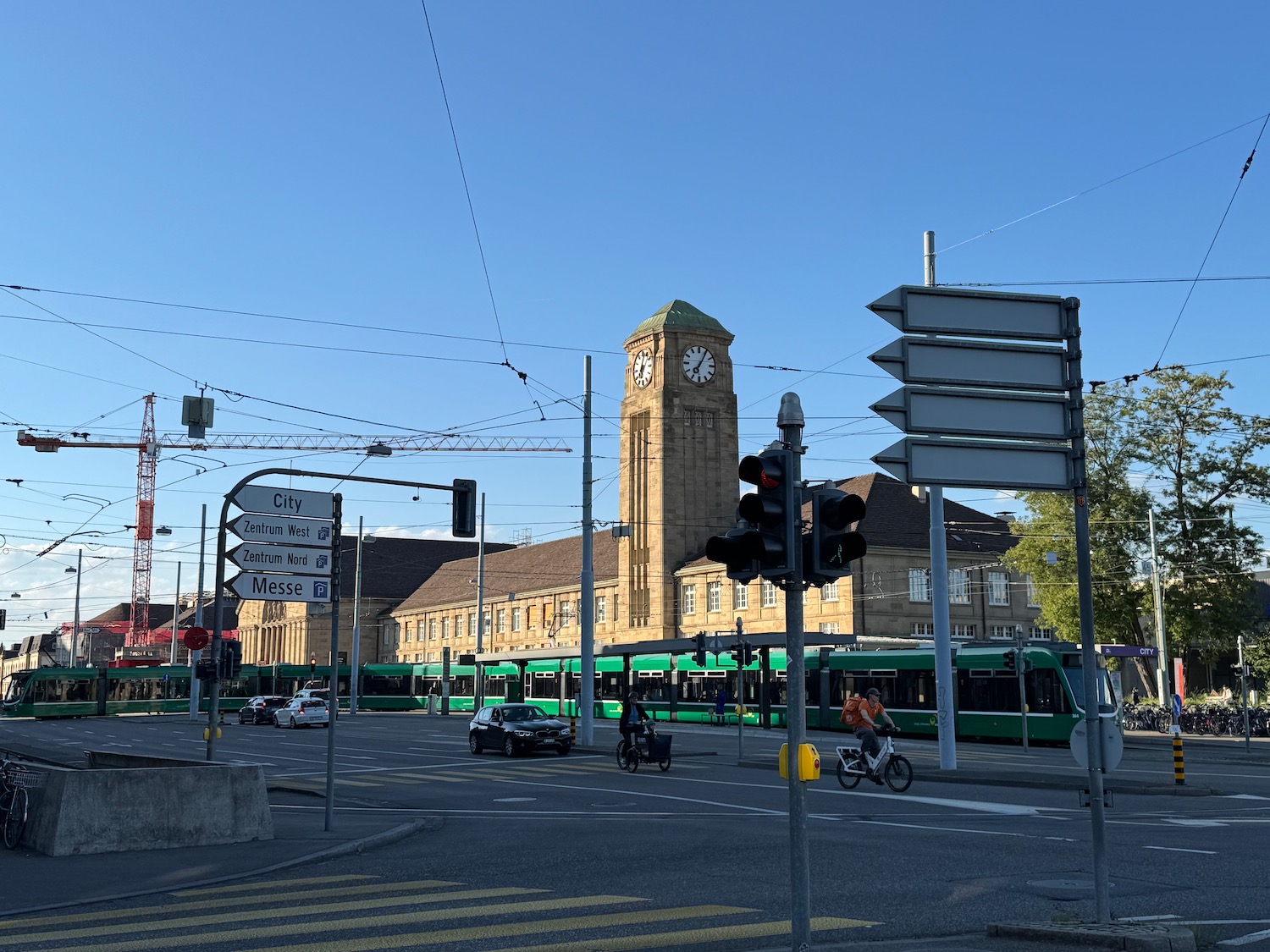 a street with a clock tower and cars on it