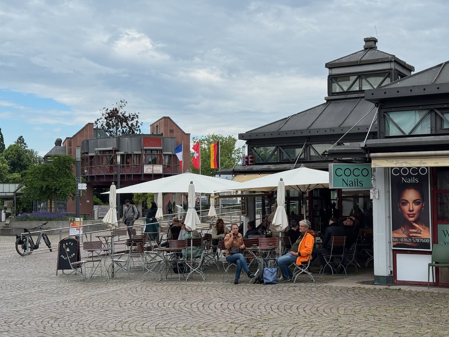 a group of people sitting at tables outside a building