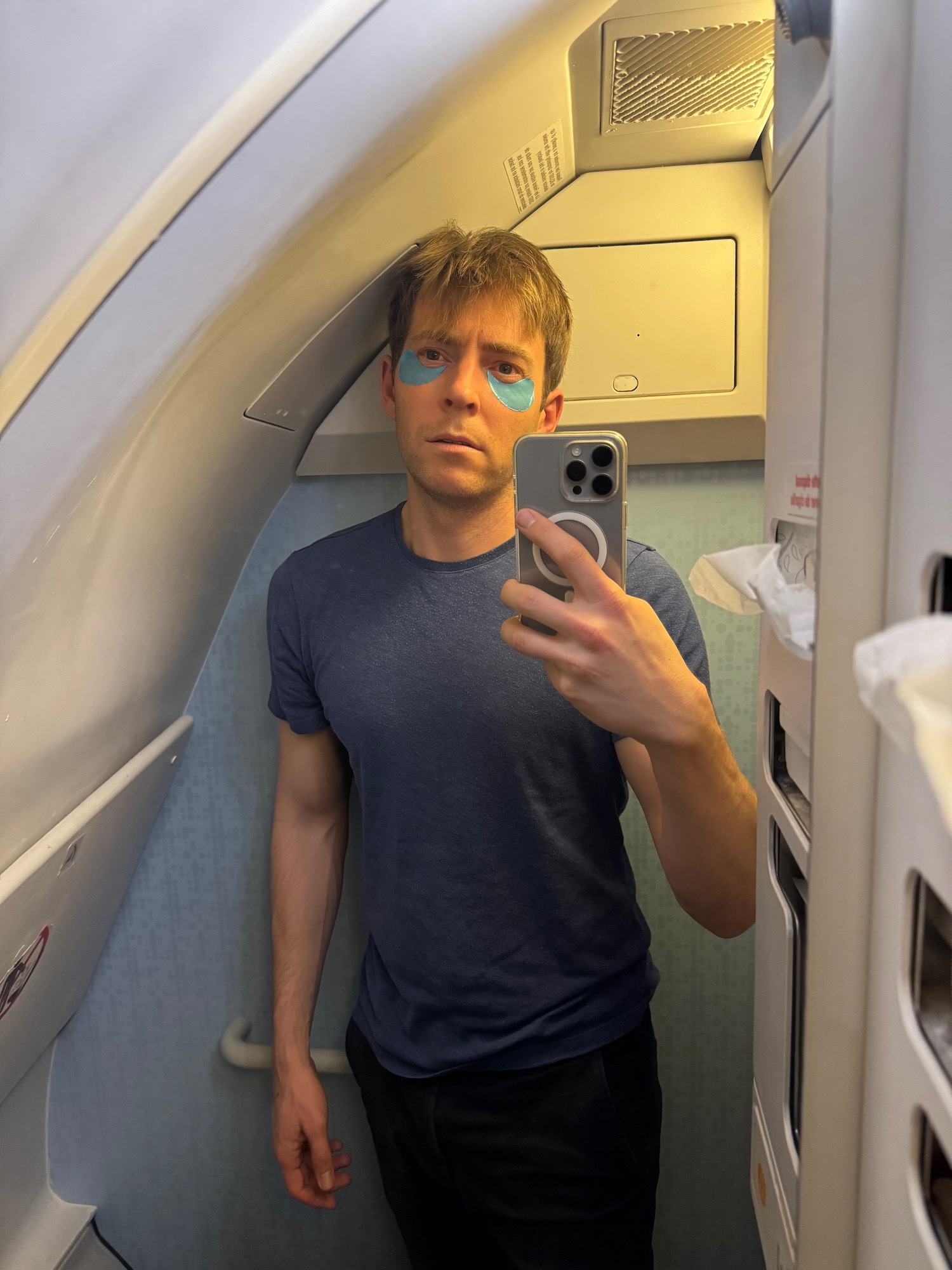 a man taking a selfie in a plane