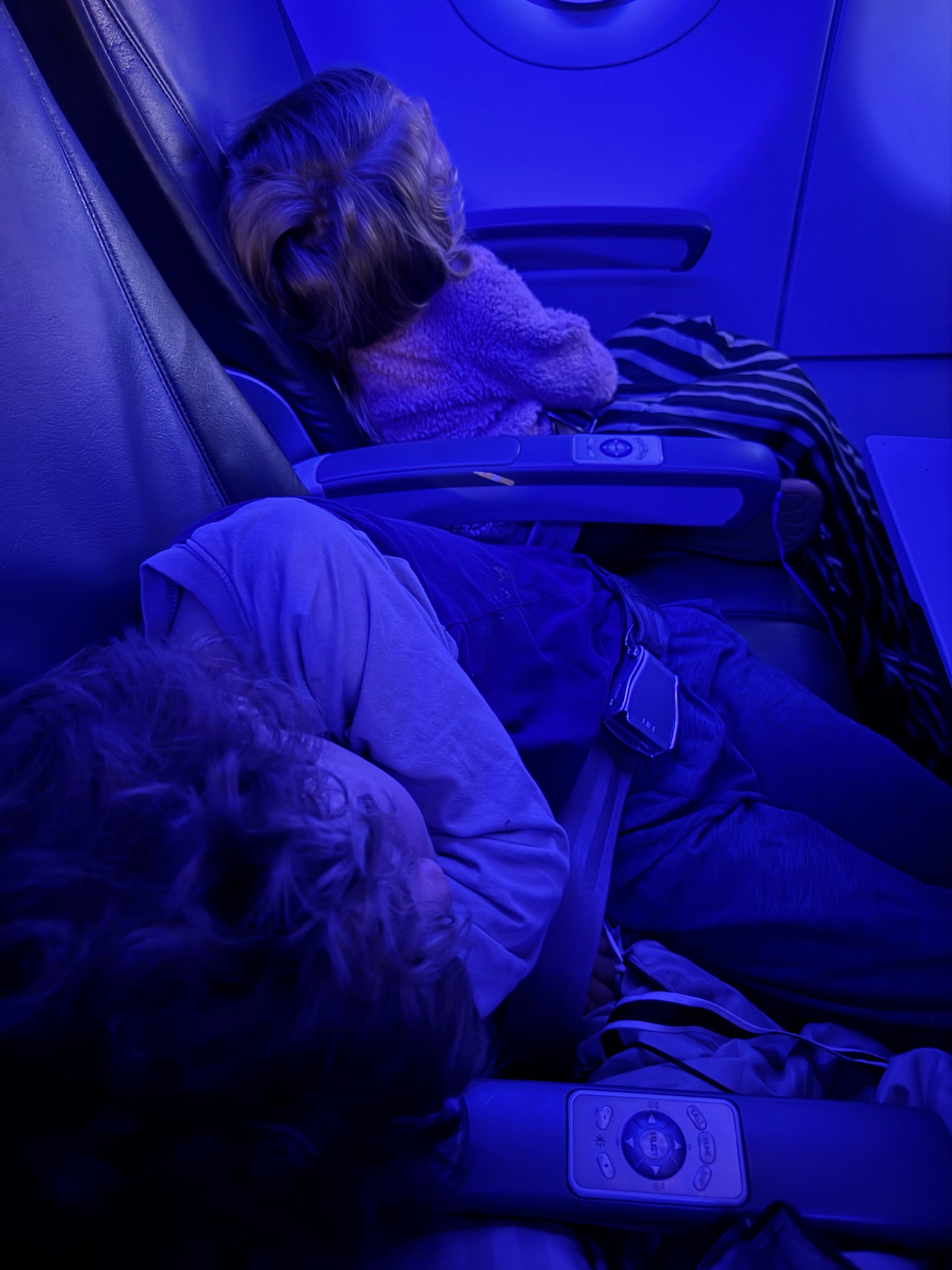 a child sleeping on a plane