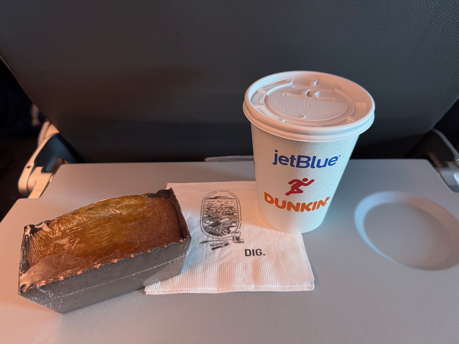 a cup of coffee and a loaf of bread on a table