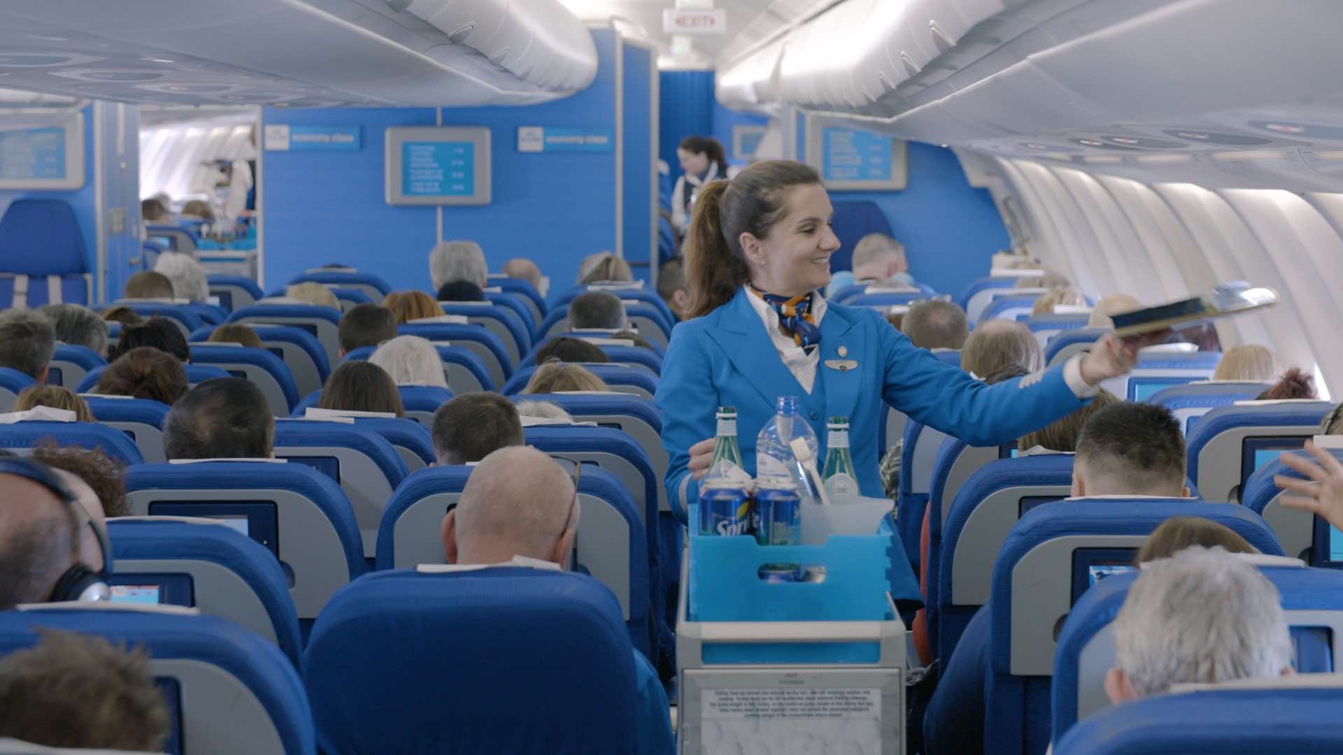 a woman in blue uniform in an airplane