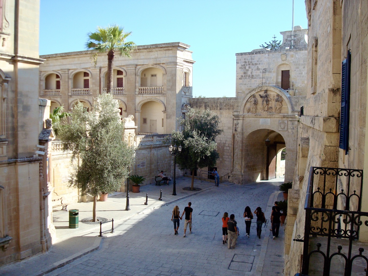 a group of people walking in a courtyard