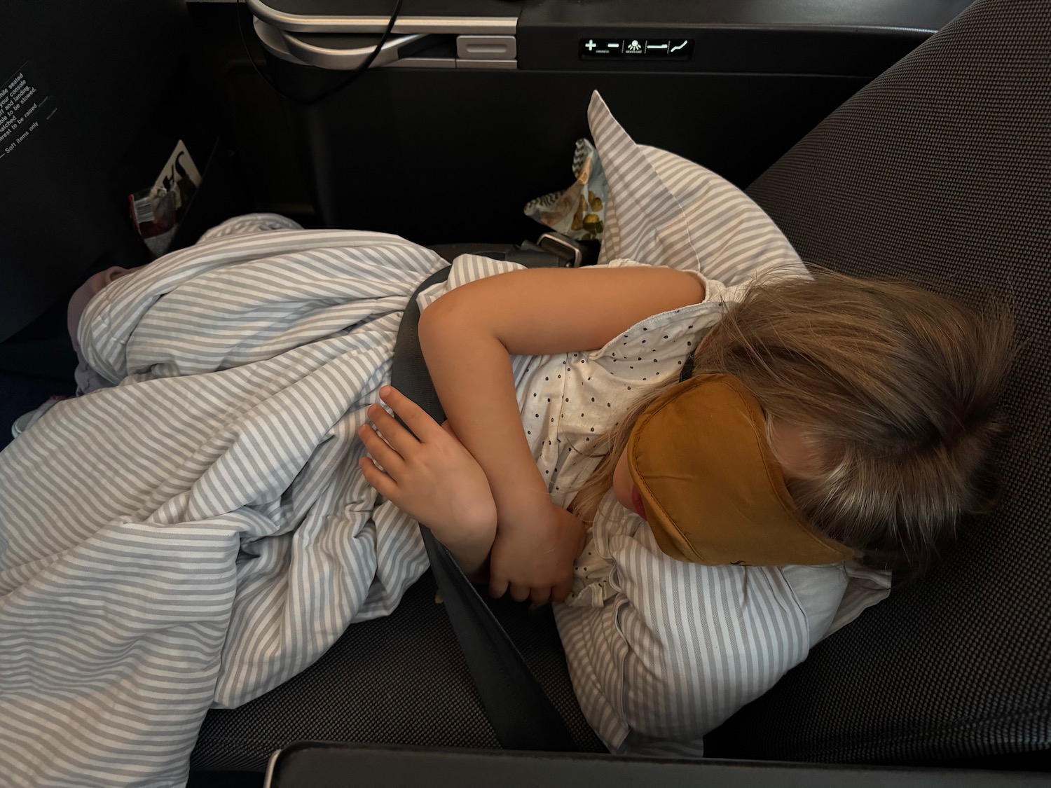 a girl sleeping in a plane
