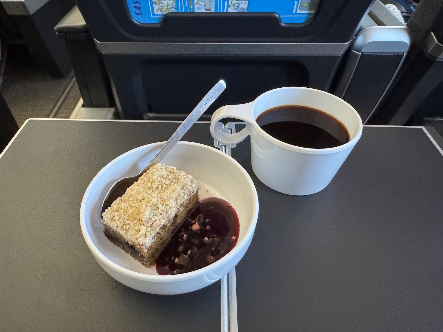 a bowl of food and a cup of coffee on a tray