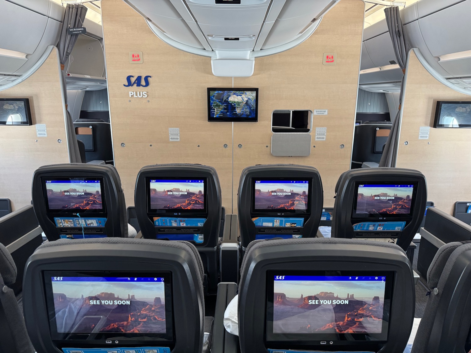 a row of seats with monitors on the back
