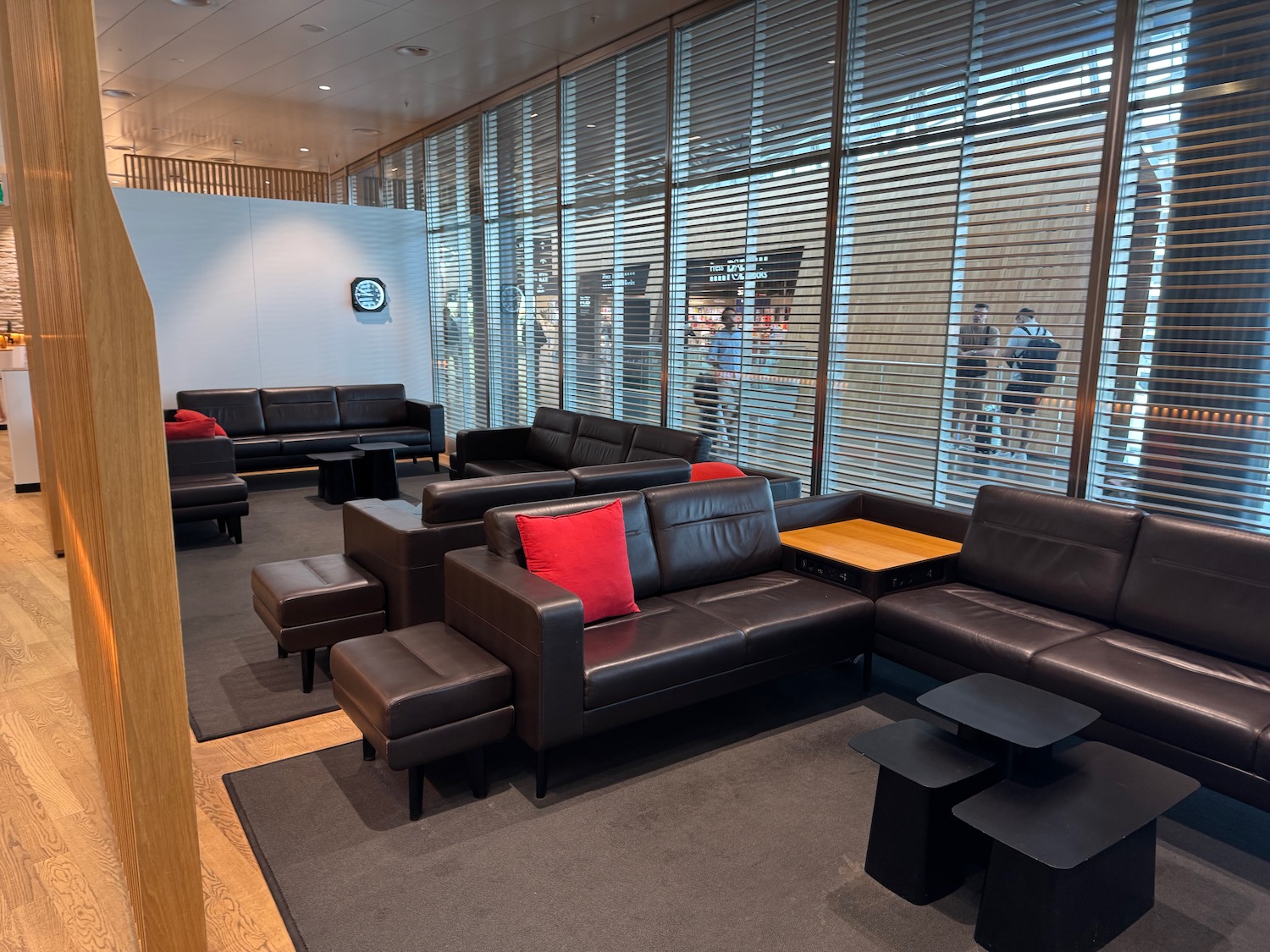 a room with leather couches and tables