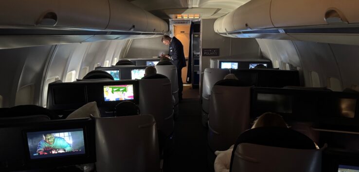 a person standing in the back of an airplane