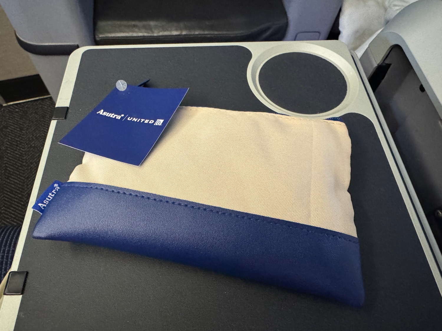 a blue and white pouch on a black surface
