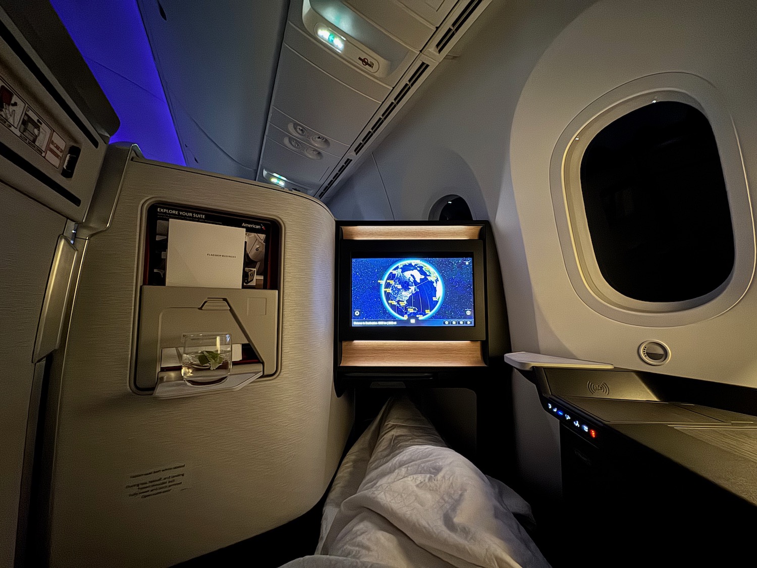 a tv on a bed in an airplane