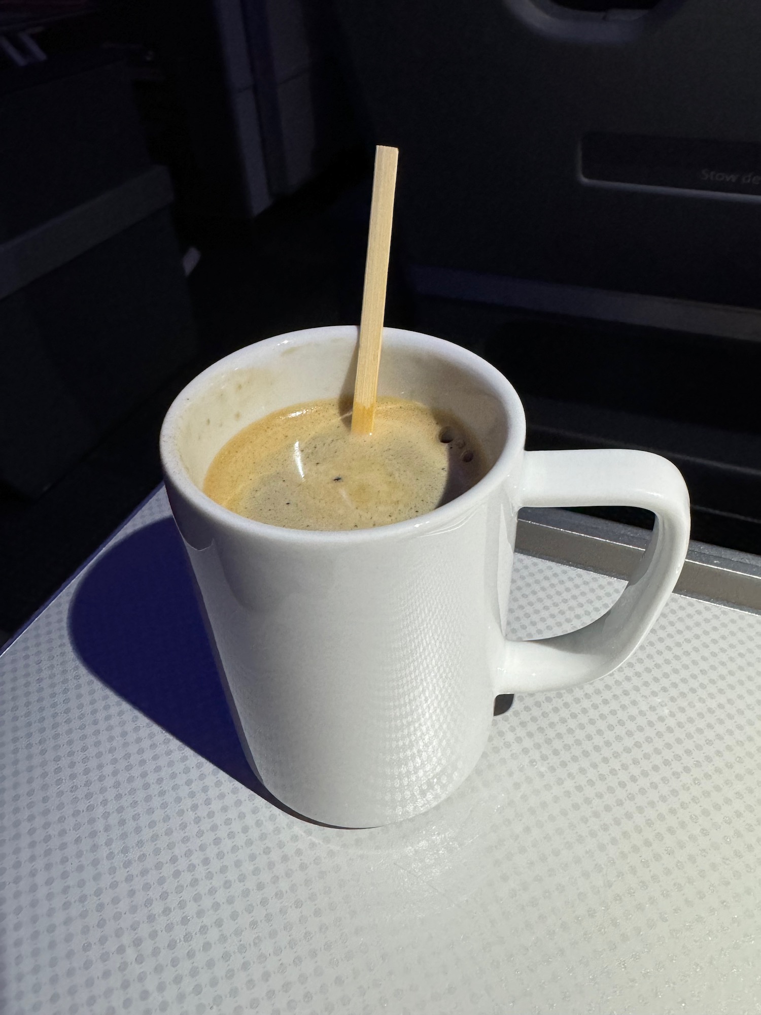 a cup of coffee with a wooden spoon