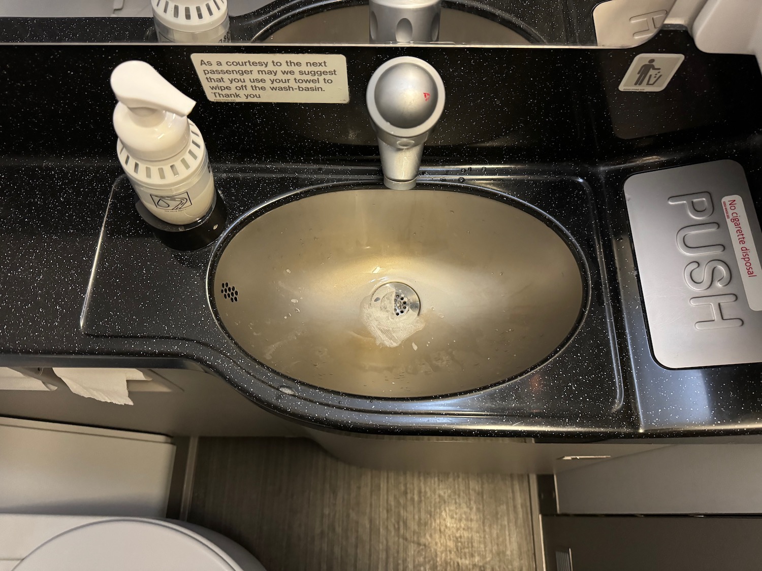 a sink with soap and soap dispenser
