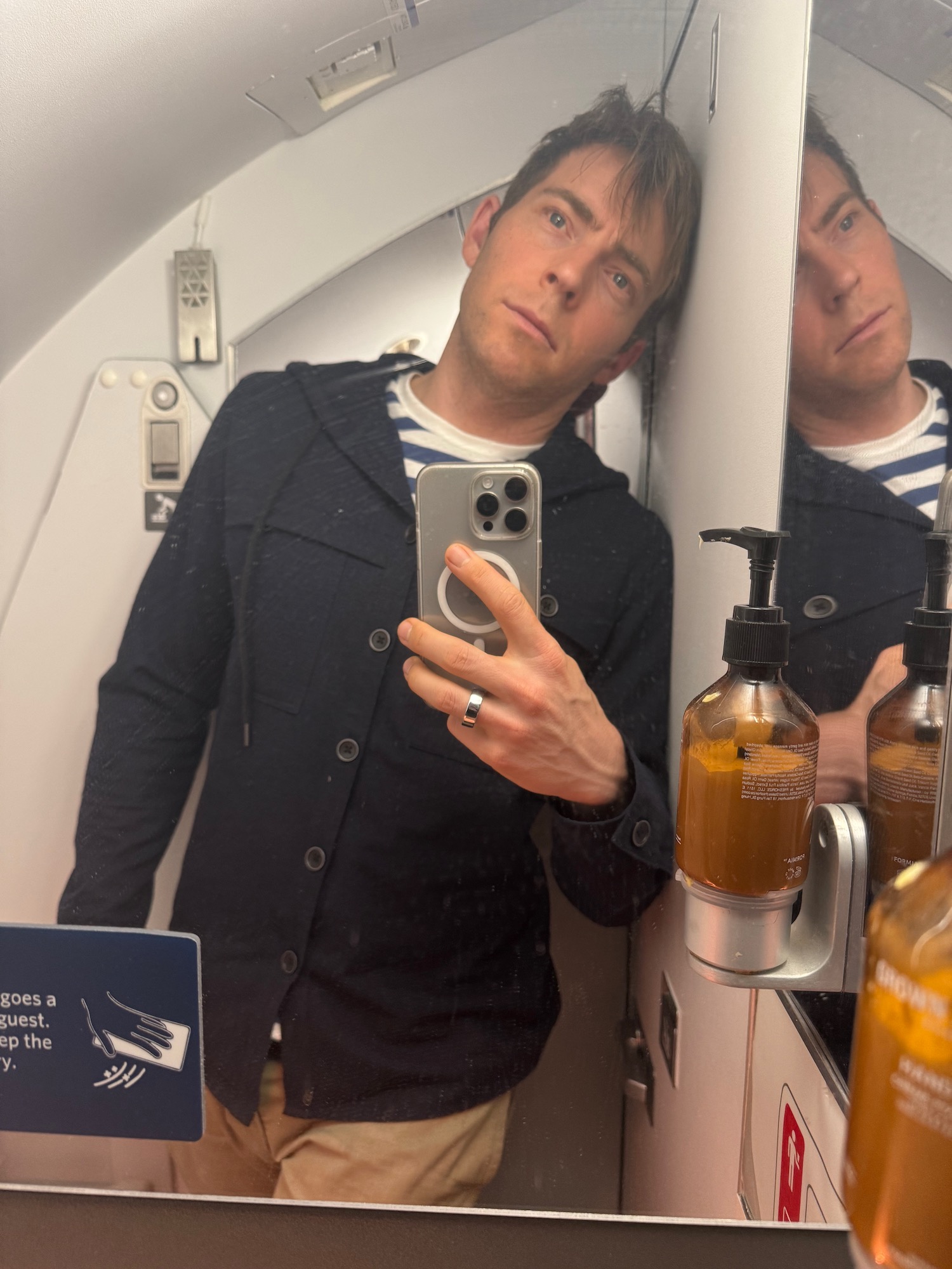 a man taking a selfie in a bathroom