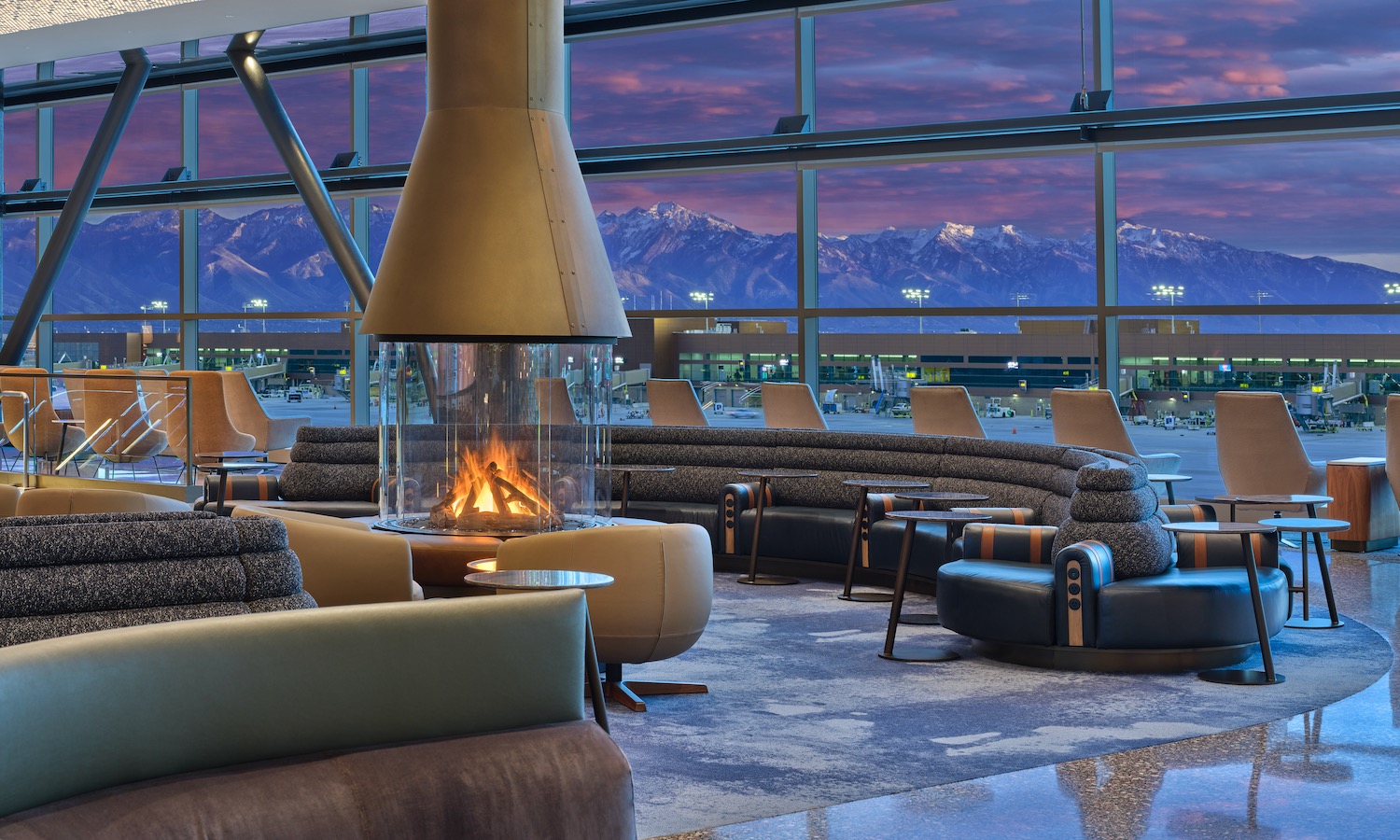 a room with a fireplace and chairs