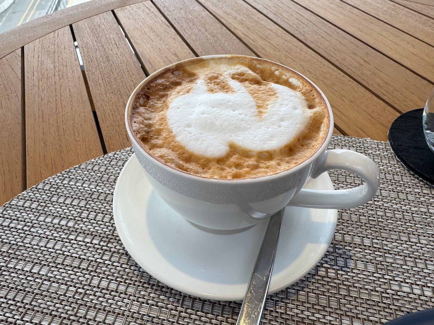 a cup of coffee with a swan design on top