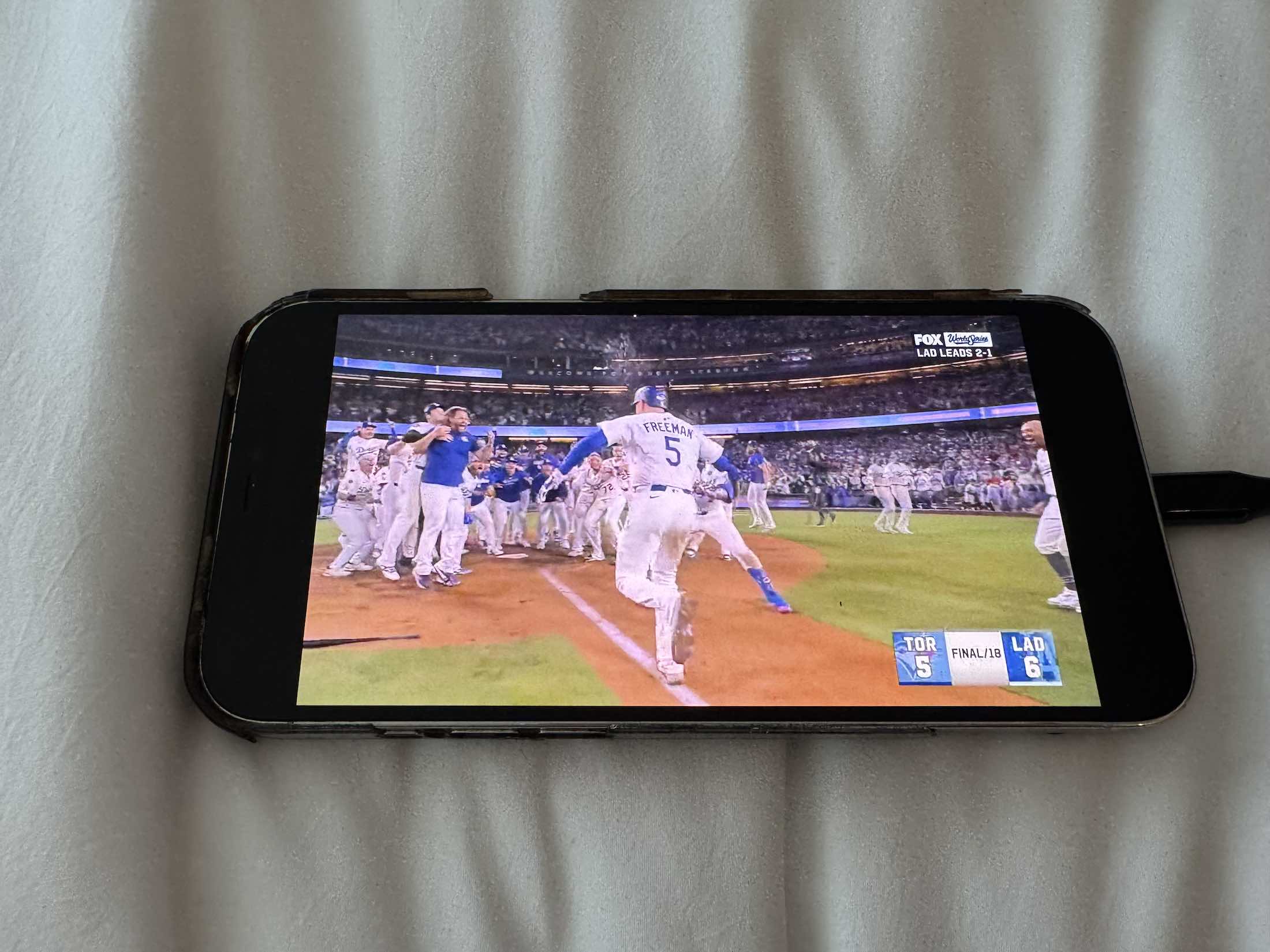 a cell phone with a screen showing a baseball game
