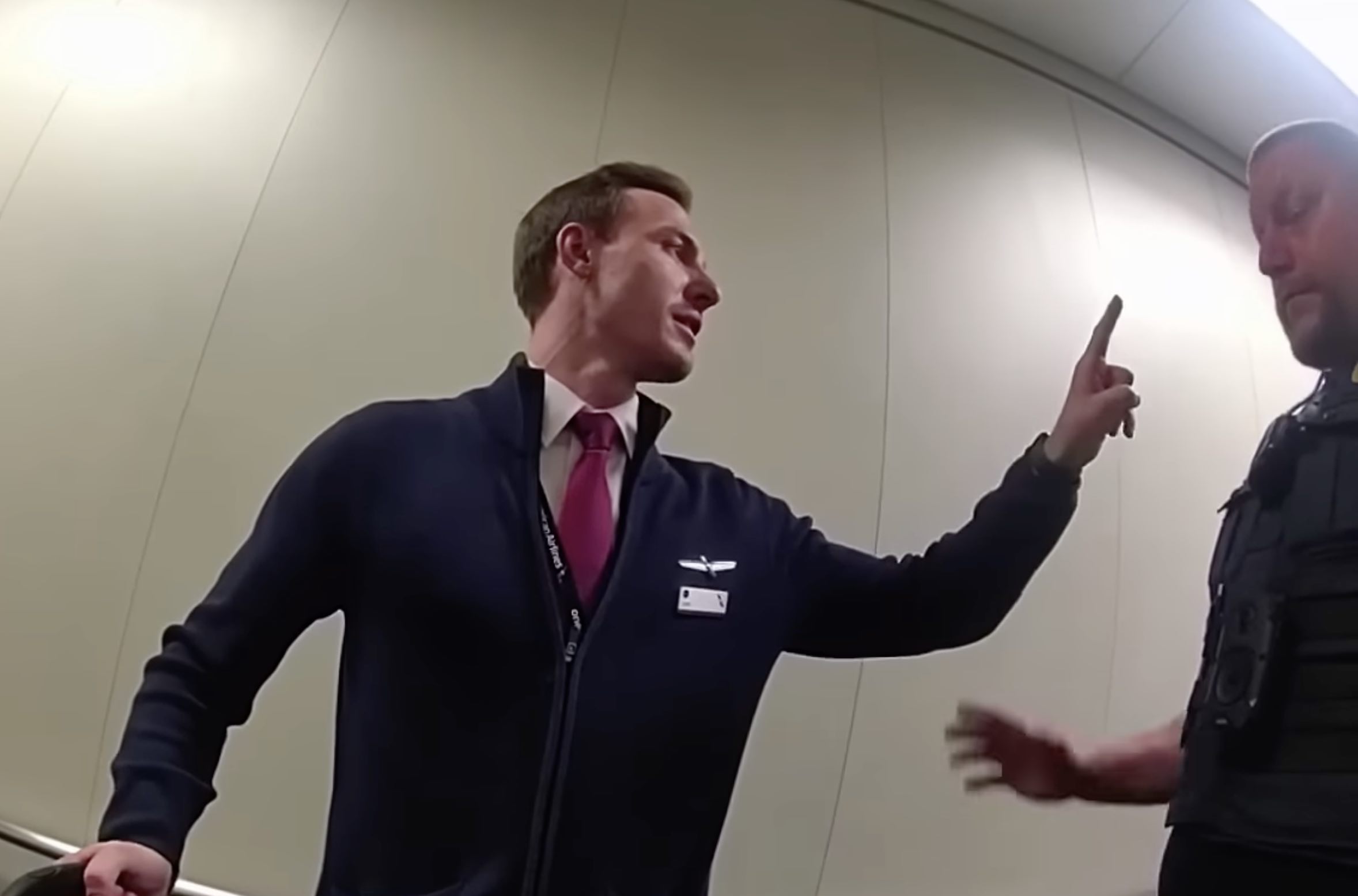 a man in a suit pointing at another man