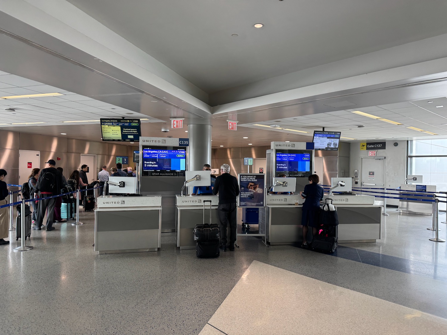 people standing in a line at an airport