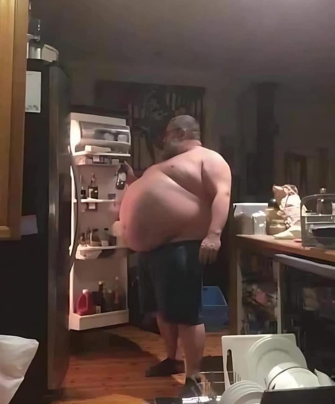 a man standing in front of a refrigerator