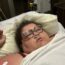 a woman lying in a hospital bed
