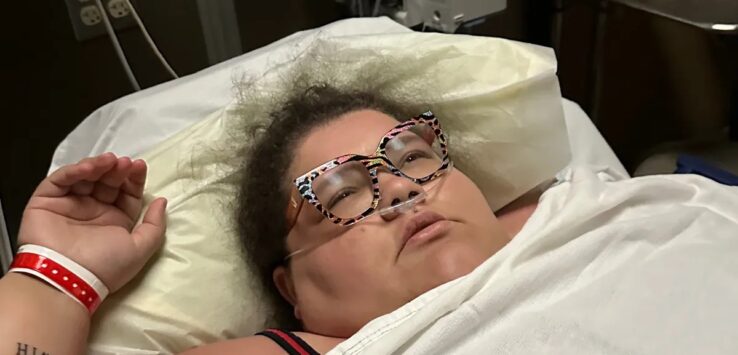 a woman lying in a hospital bed