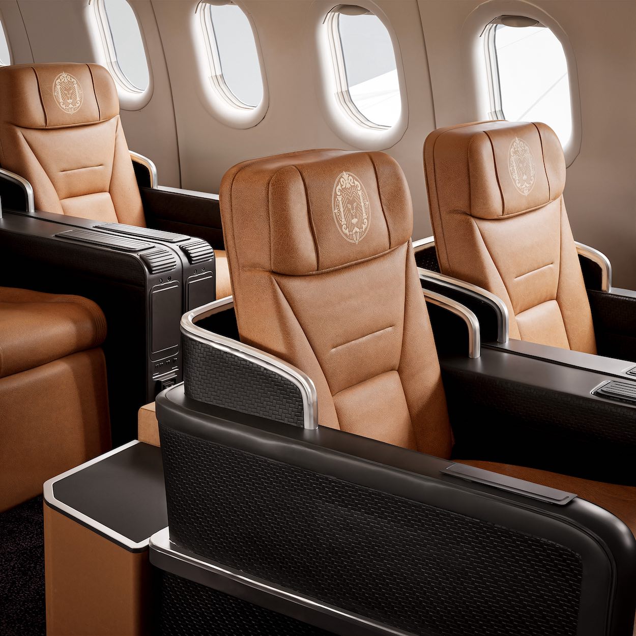 a row of brown leather seats in an airplane