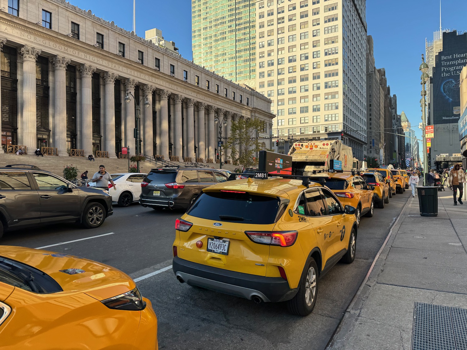 a group of yellow cars on a street