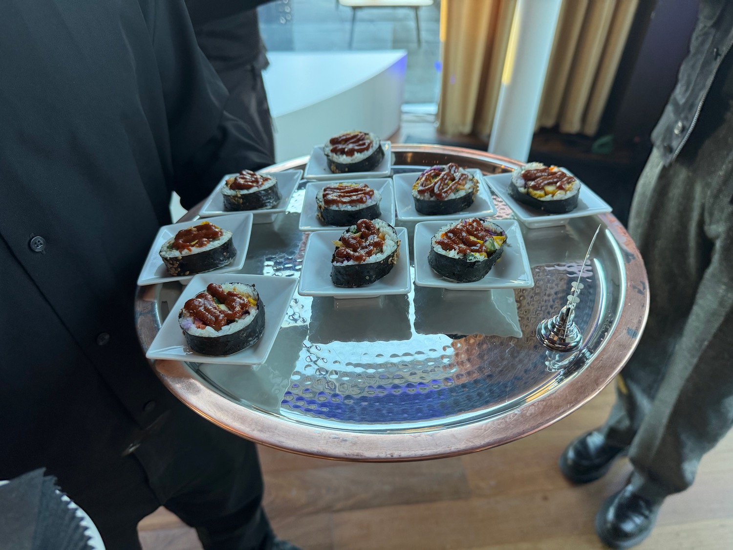 a tray of sushi on a silver tray