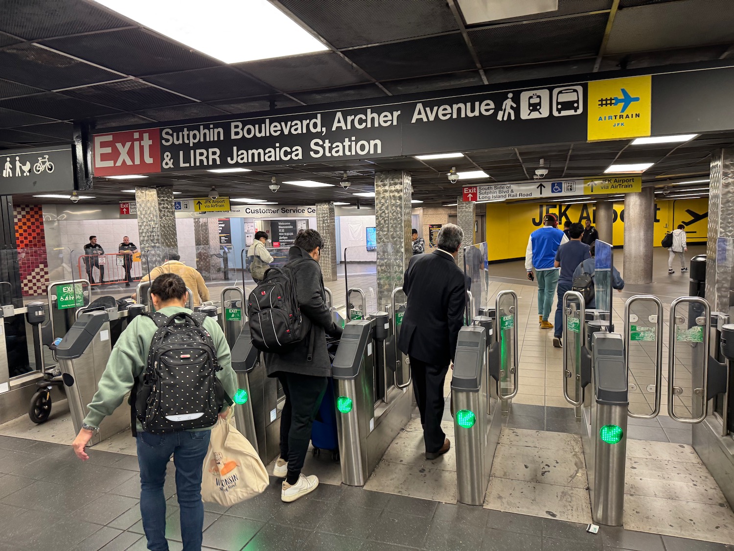 a group of people standing in a subway station