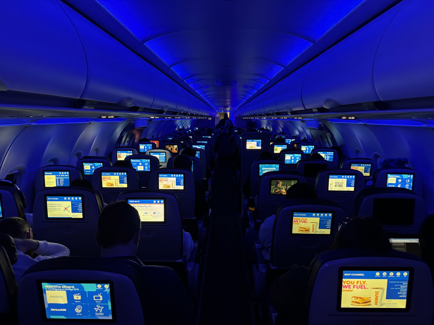 a row of seats with monitors on them