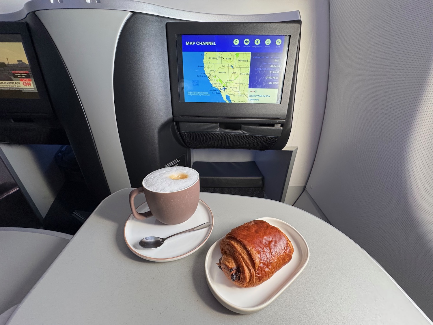 a cup of coffee and a pastry on a plate