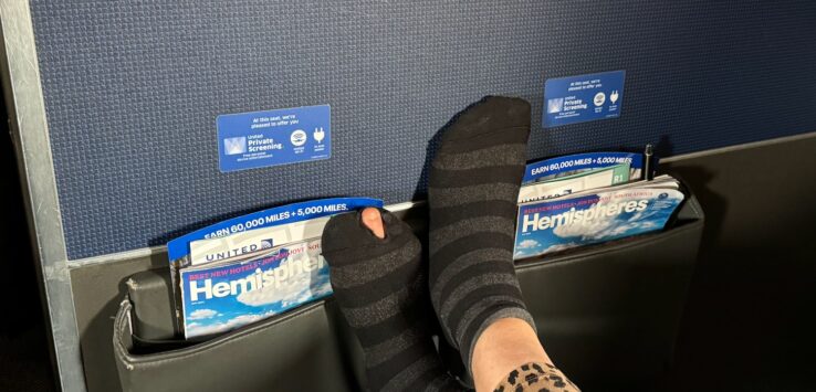 a person's feet in a pocket of a magazine