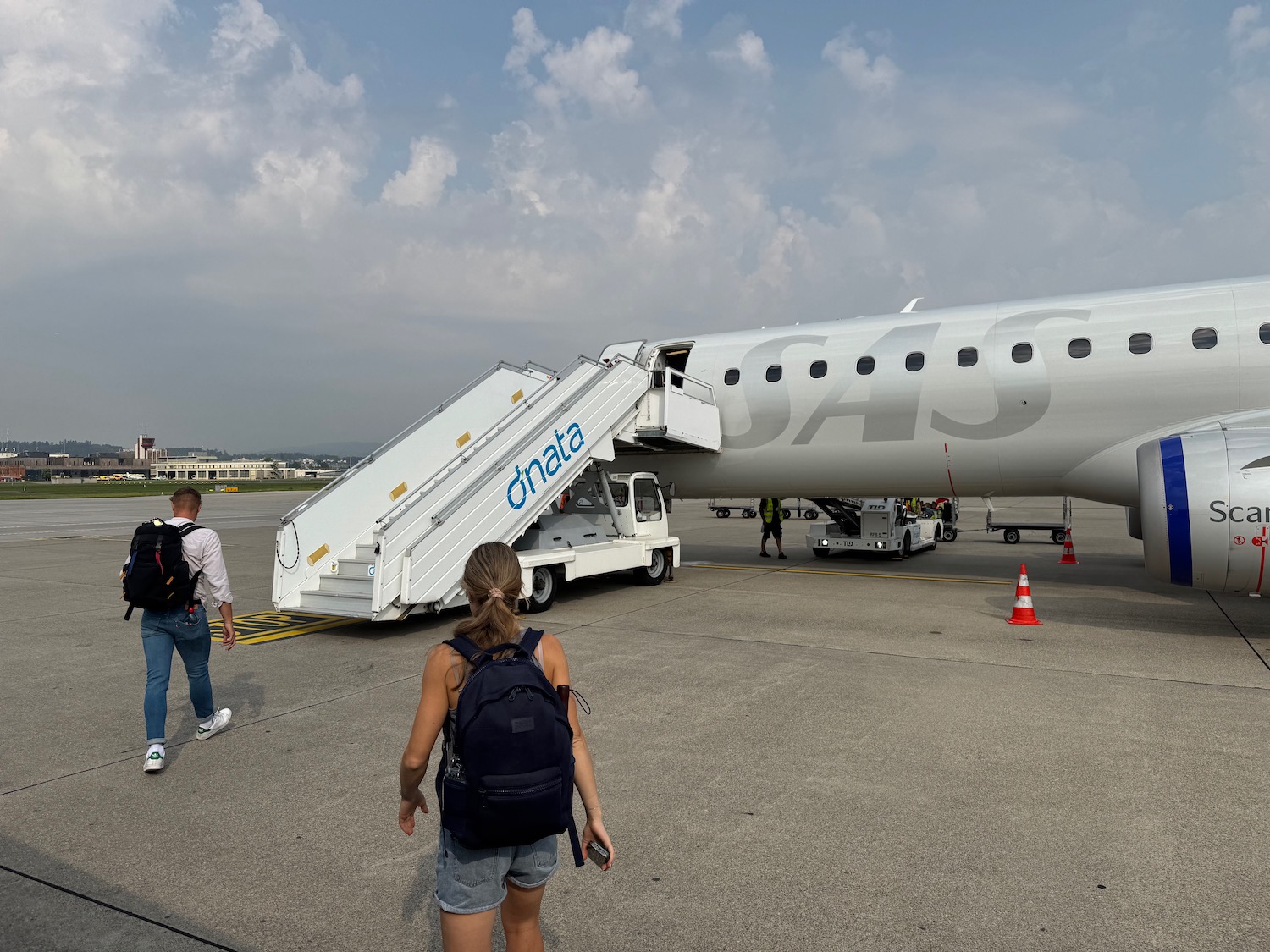 people walking towards an airplane