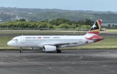 a white airplane on a runway