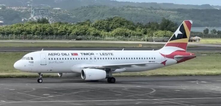 a white airplane on a runway